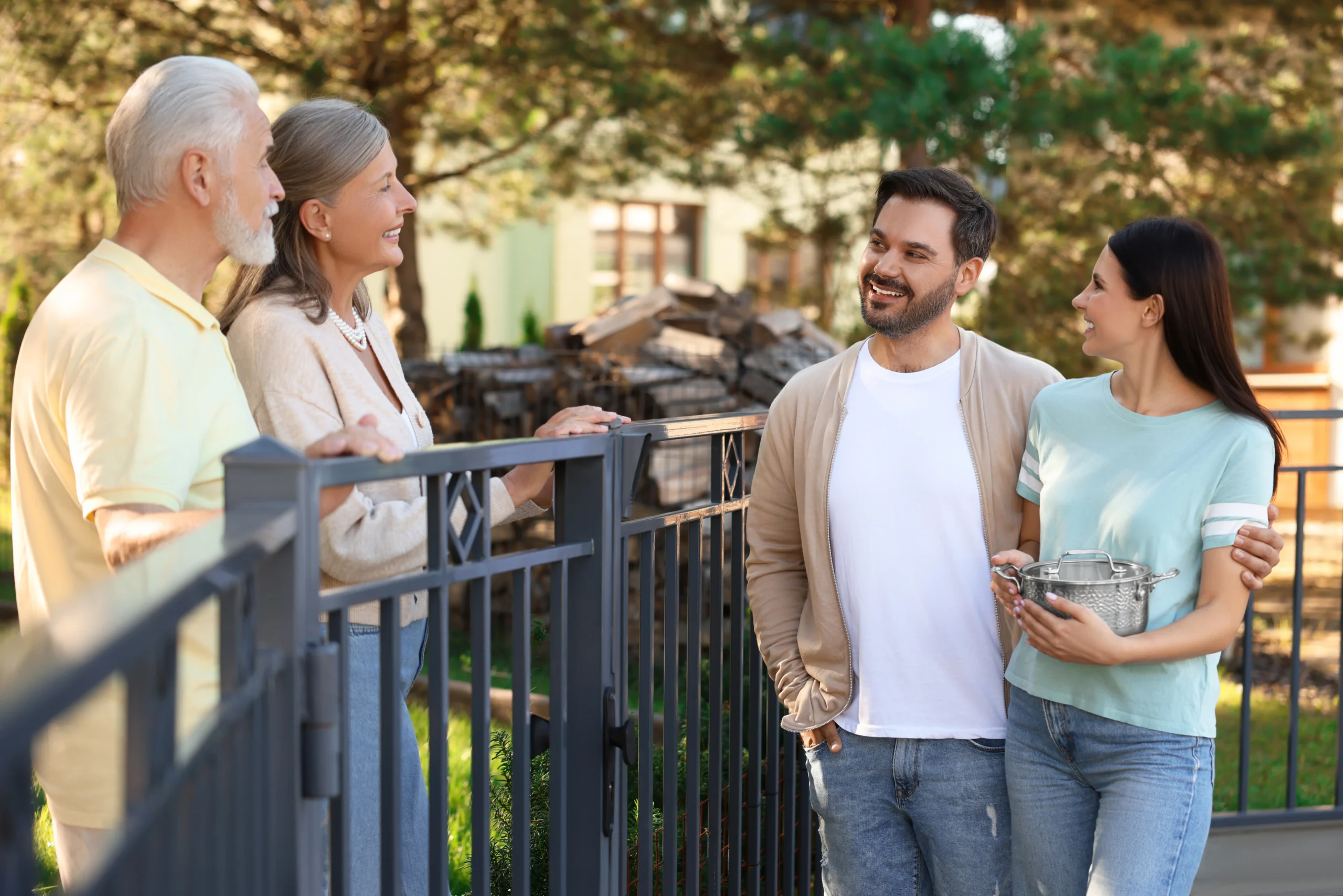 Neighbours maintaining a friendly relationship while discussing building works near a fence